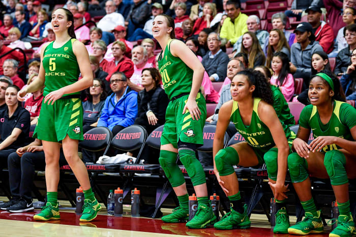 Sabrina Ionescu, Satou Sabally, and two of their Oregon teammates on the bench